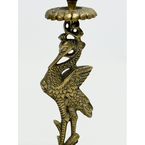 350 - A pair of Early 20th Century brass peacock candlesticks. 11x19cm