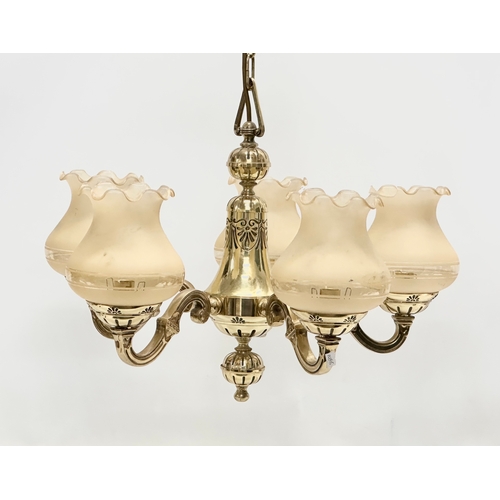 573 - A Mid 20th Century brass chandelier with glass shades. 51x43cm.