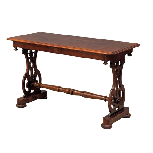 1174 - A mid Victorian mahogany side table with stretcher and open fret decoration, circa 1860s. 97cm x 44c... 