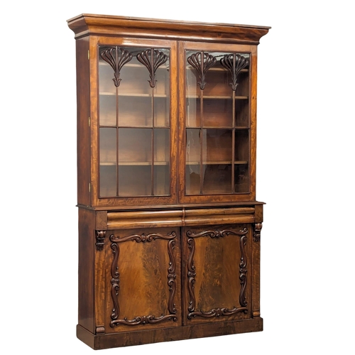 1183 - An ornate Early Victorian mahogany bookcase. Circa 1840-50. 154x43x238cm