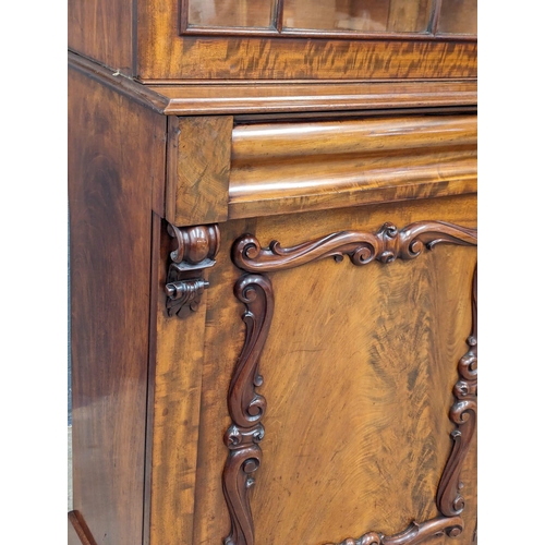 1183 - An ornate Early Victorian mahogany bookcase. Circa 1840-50. 154x43x238cm