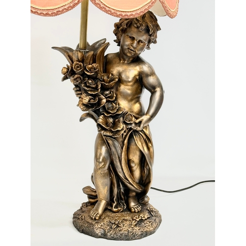 560 - A large gilt painted figurine table lamp. 89cm