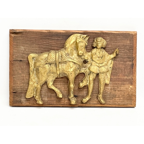 552 - A Late 19th/Early 20th Century brass wall plaque. 28x17cm