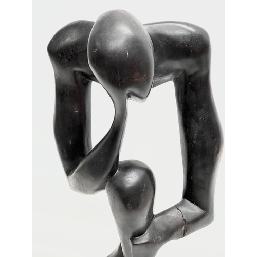 551 - A large Early/Mid 20th Century carved ebonised padauk sculpture. In the style of Henry Moore. 60cm