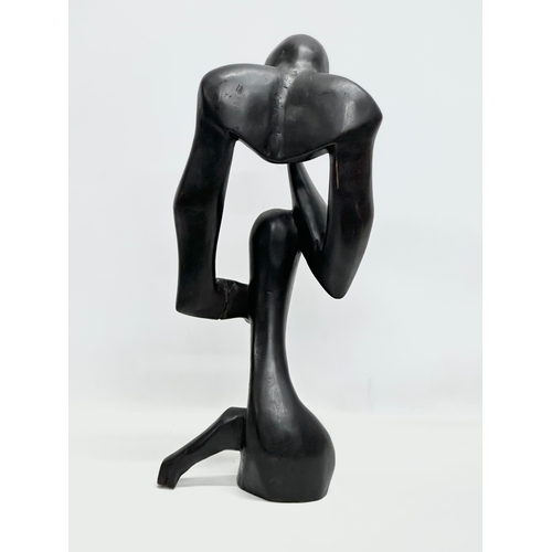 551 - A large Early/Mid 20th Century carved ebonised padauk sculpture. In the style of Henry Moore. 60cm