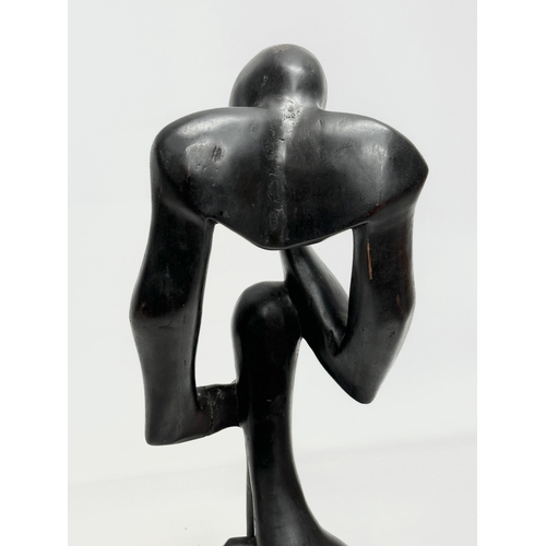 551 - A large Early/Mid 20th Century carved ebonised padauk sculpture. In the style of Henry Moore. 60cm