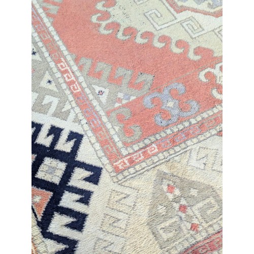 1193 - A large vintage Middle Eastern style hand knotted rug. 204x306cm