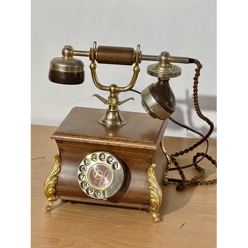 8 - An old style wood and brass telephone.