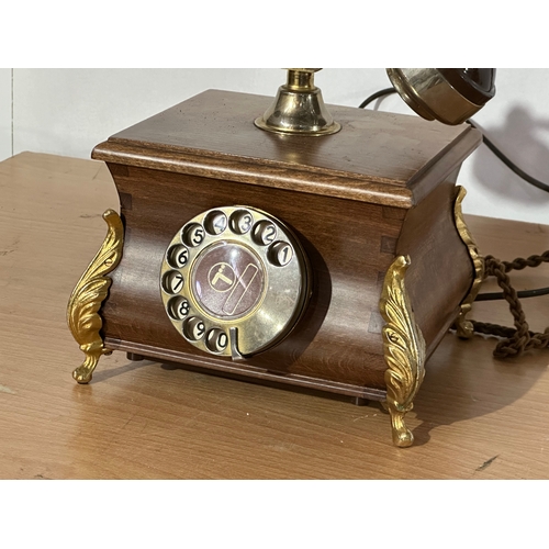 8 - An old style wood and brass telephone.