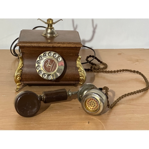 8 - An old style wood and brass telephone.