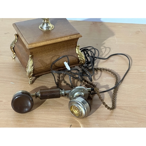 8 - An old style wood and brass telephone.