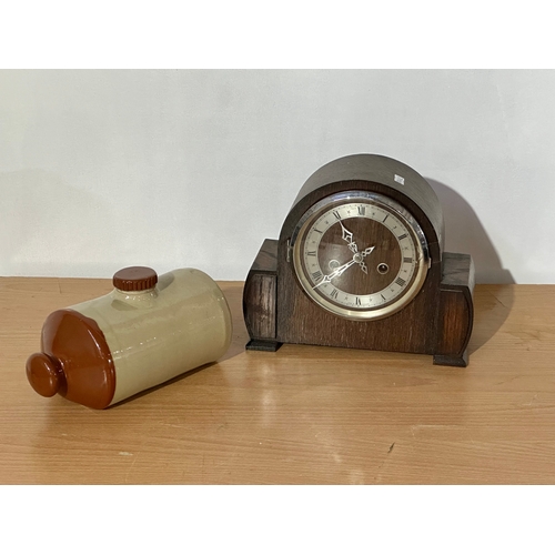 9 - A vintage Enfield mantle clock with key and pendulum. Together with a stone water bottle