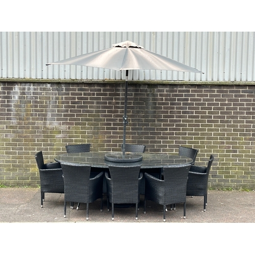 23 - A large garden table and 8 chairs. 220x120x75cm