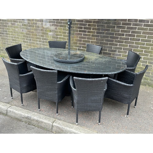 23 - A large garden table and 8 chairs. 220x120x75cm