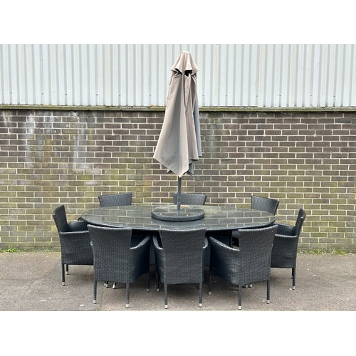 23 - A large garden table and 8 chairs. 220x120x75cm