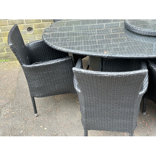 23 - A large garden table and 8 chairs. 220x120x75cm