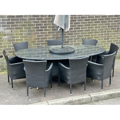 23 - A large garden table and 8 chairs. 220x120x75cm