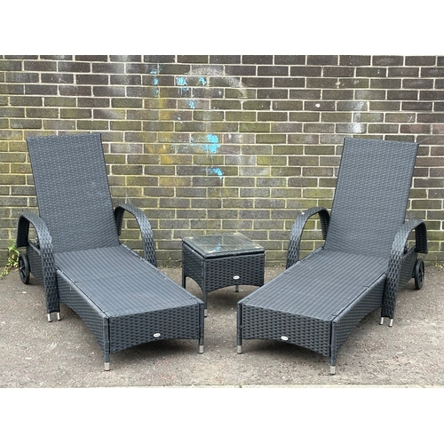 24 - A pair of large garden loungers and matching side table. 201cm down.