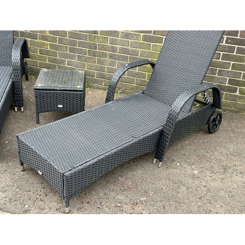 24 - A pair of large garden loungers and matching side table. 201cm down.