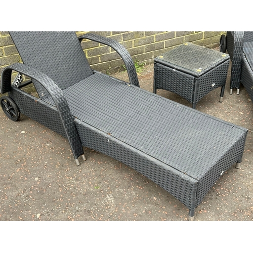 24 - A pair of large garden loungers and matching side table. 201cm down.