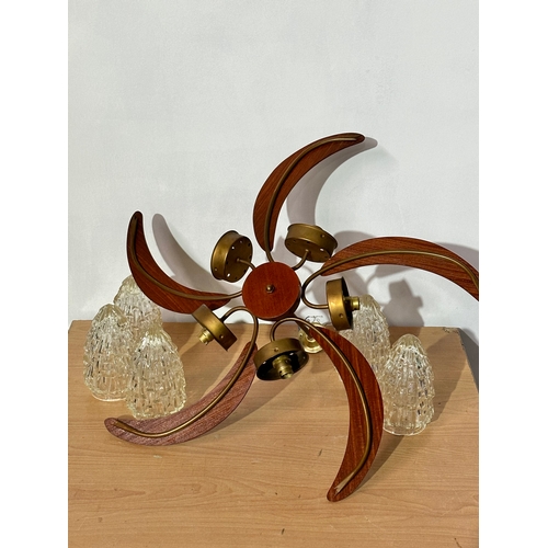 25 - A large Mid Century teak ceiling light with glass shades. 70x35cm.