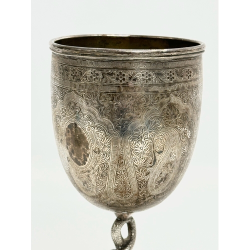 1 - A pair of Late 19th Century Anglo-Indian Kutch silver goblets. With twist serpent stems on raised ci... 