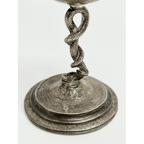 1 - A pair of Late 19th Century Anglo-Indian Kutch silver goblets. With twist serpent stems on raised ci... 