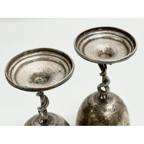 1 - A pair of Late 19th Century Anglo-Indian Kutch silver goblets. With twist serpent stems on raised ci... 