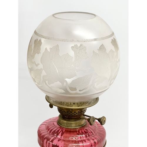 63 - A large Victorian telescopic double burner oil lamp with ruby glass bowl, reeded column and Early 20... 