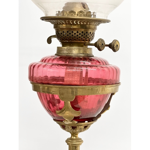 63 - A large Victorian telescopic double burner oil lamp with ruby glass bowl, reeded column and Early 20... 