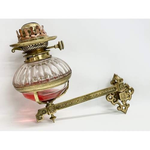 65 - A pair of Victorian wall bracket double burner oil lamps with slice cut bowls. 30x27cm