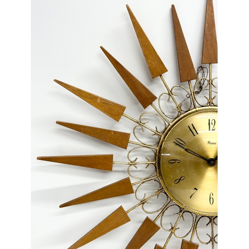 137 - A 1960’s Mid Century teak sunburst clock by Paico. 52cm