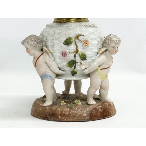 149 - A near pair of Late 19th/Early 20th Century German porcelain oil lamps. With Cupid and crusted flowe... 