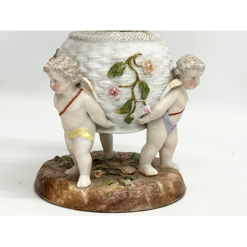 149 - A near pair of Late 19th/Early 20th Century German porcelain oil lamps. With Cupid and crusted flowe... 