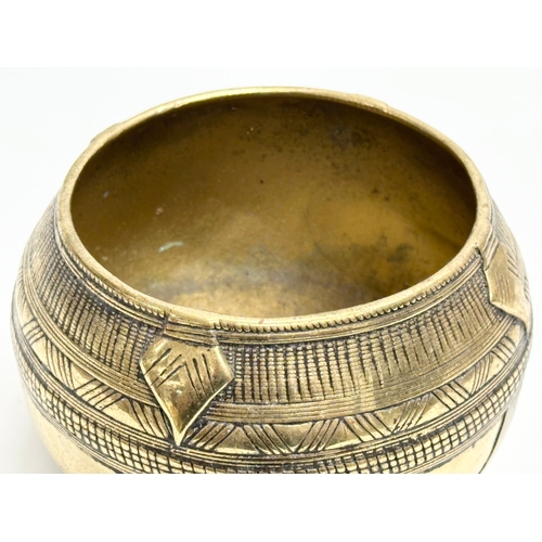 181 - An Early 20th Century Indian brass rice measuring bowl. 13x11cm.