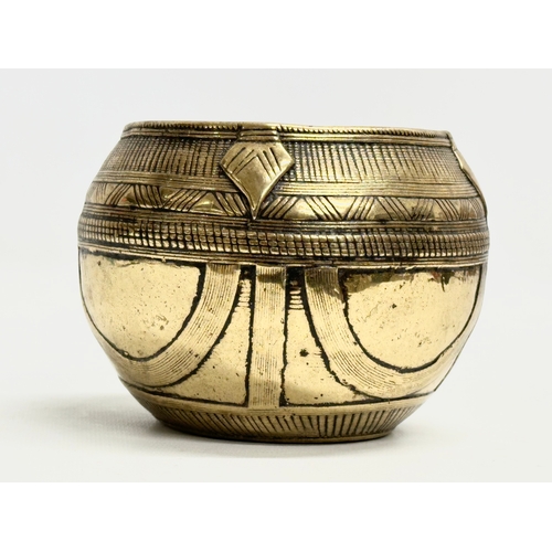 181 - An Early 20th Century Indian brass rice measuring bowl. 13x11cm.