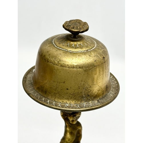 429 - An Early 20th Century brass counter bell. 25cm