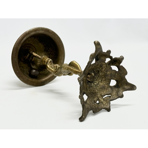 429 - An Early 20th Century brass counter bell. 25cm