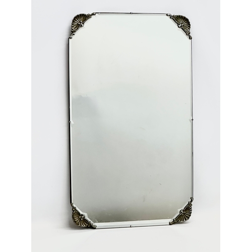 432 - An early 20th century bevelled mirror. 69x41cm S