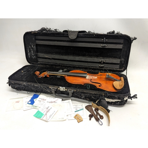 433 - An early 20th century violin with Antonius Stradivarius label, including violin chords, etc.