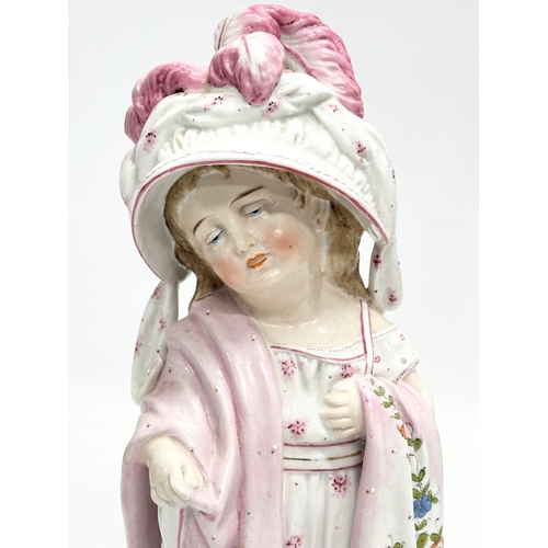 86 - A pair of Late 19th Century German hand painted porcelain ‘Mama Papa’ figurines. 27cm