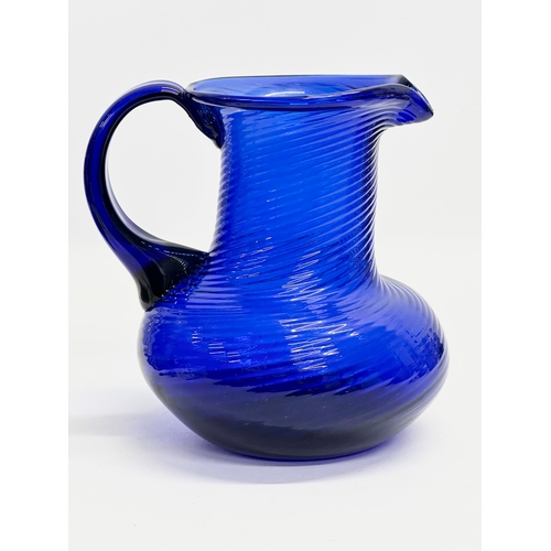 56 - A Late 19th Century Bristol Blue glass water jug. 18x29x21cm.