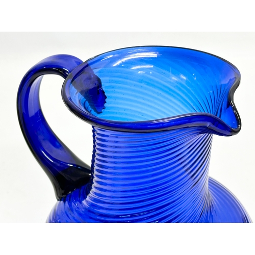 56 - A Late 19th Century Bristol Blue glass water jug. 18x29x21cm.