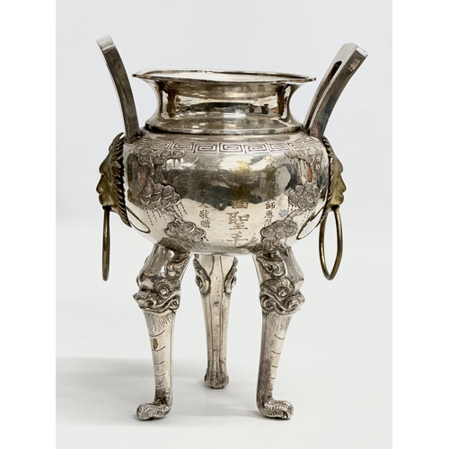 94 - A 20th Century Chinese silver plated urn. Raised on 3 Foo Dog feet, with brass lion mask ring handle... 