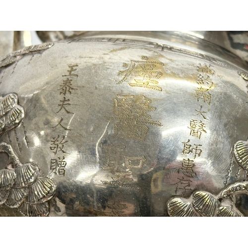 94 - A 20th Century Chinese silver plated urn. Raised on 3 Foo Dog feet, with brass lion mask ring handle... 