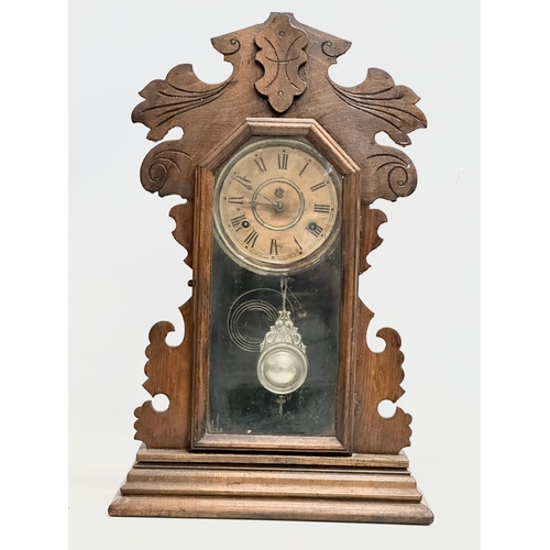 434 - A Late 19th Century American Gingerbread clock by Waterbury Clock & Co, USA. With key and pendulum. ... 