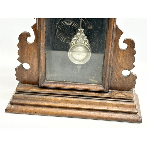 434 - A Late 19th Century American Gingerbread clock by Waterbury Clock & Co, USA. With key and pendulum. ... 