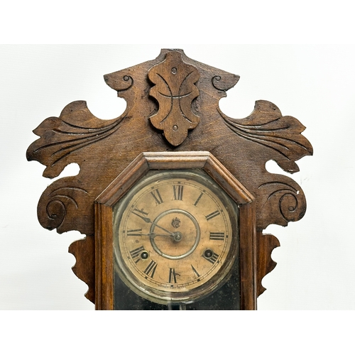 434 - A Late 19th Century American Gingerbread clock by Waterbury Clock & Co, USA. With key and pendulum. ... 