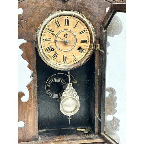 434 - A Late 19th Century American Gingerbread clock by Waterbury Clock & Co, USA. With key and pendulum. ... 