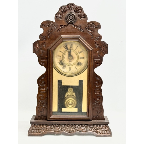 435 - A Late 19th Century American Gingerbread clock. With pendulum. 36x12x57cm.